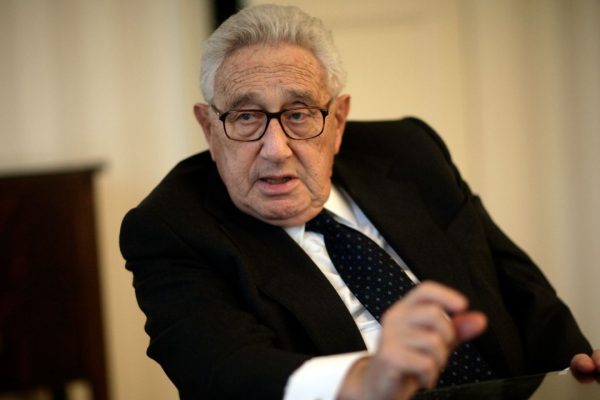 Henry Kissinger met with China’s top diplomat and sanctioned defense minister in Beijing on Thursday, a day after the U.S. imposed sanctions on the two officials for their role in the disputed South China Sea.